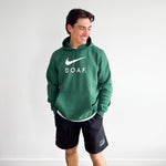Anson Aroz wearing a green hoodie with Nike Logo and DOAF text, standing against a plain background