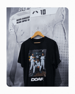 DOAF Tee featuring Dante Moore, Dakorien Moore, and Matayo Uiagalelei hanging up on Matayo's locker. 