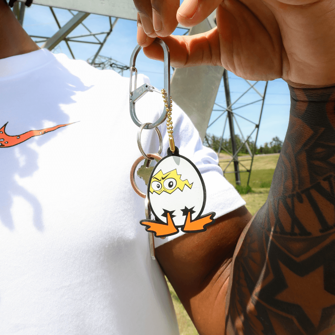 Someone holding a keychain with a DOAF character