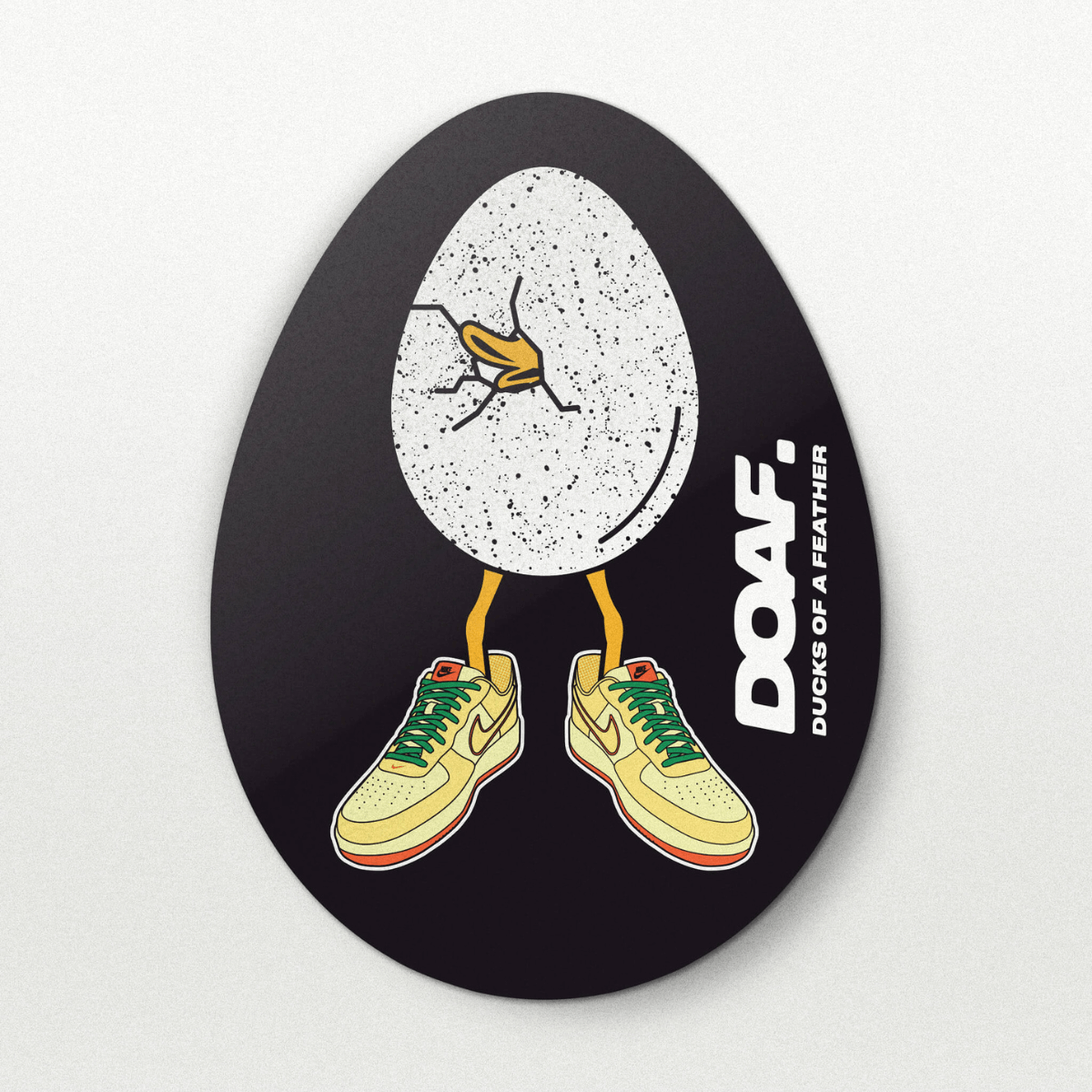Circular sticker with cartoon duck in sneakers and 'DOAF' branding on a black background