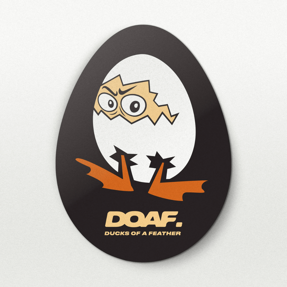 Circular sticker with cartoon duck design and 'DOAF' text on a white background
