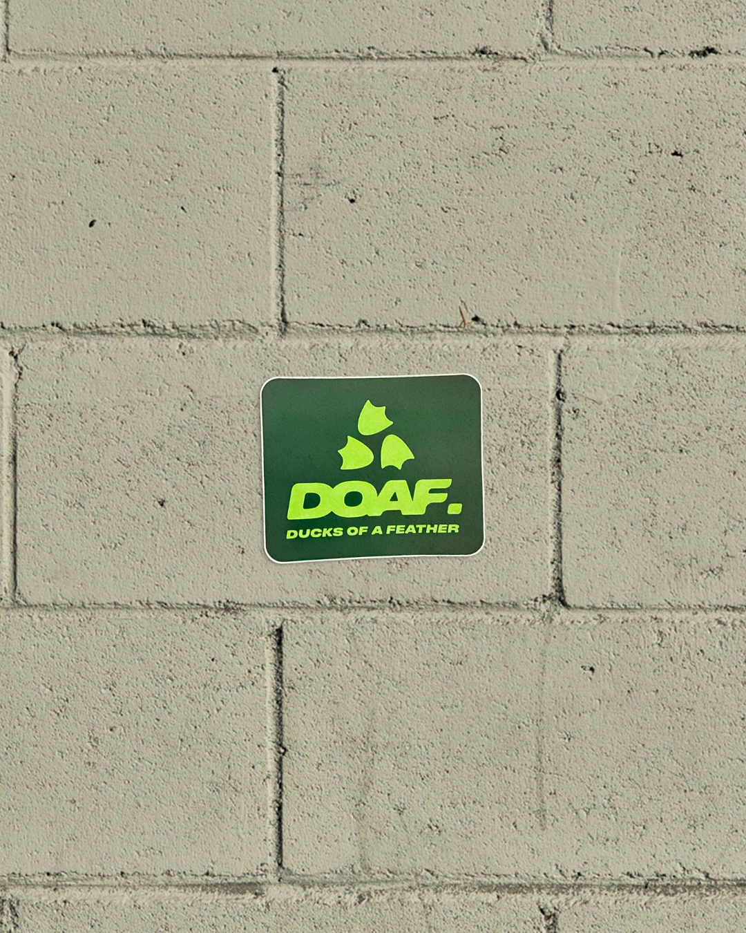 Green 'DOAF' logo on a concrete wall