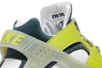 The design features premium construction with neon green leather overlays surrounding the Huarache’s iconic neoprene bootie. 