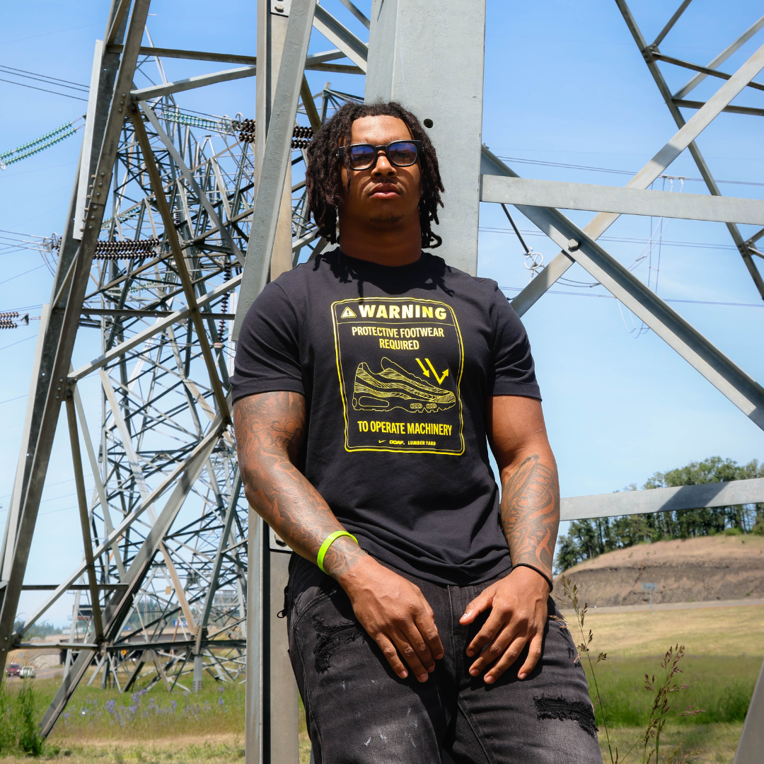 Jordon wearing a black DOAF tee with sneaker graphic