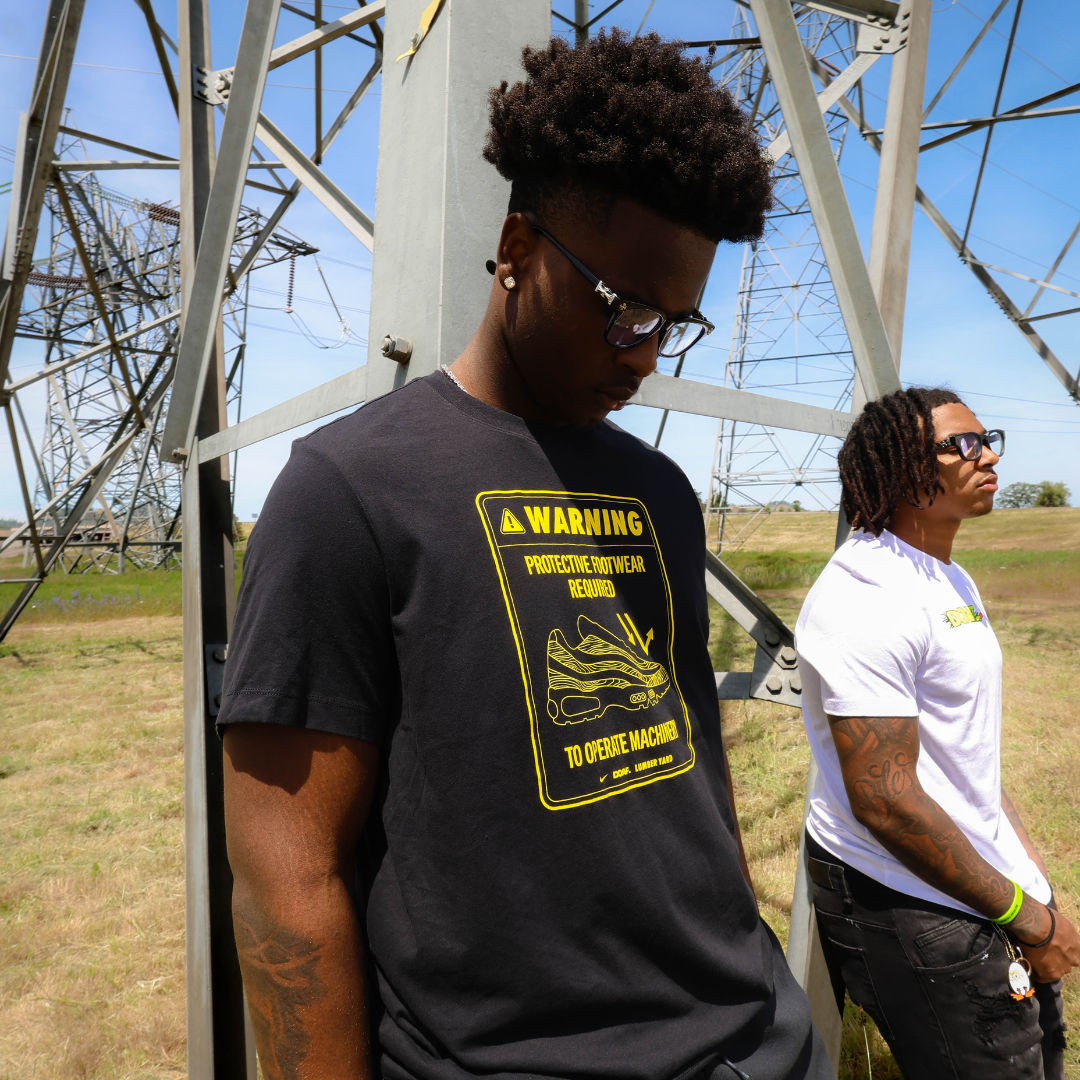 Two men outside wearing DOAF tees