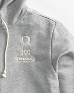 Logo detail of Gray Speedway zip up hoodie on a white background