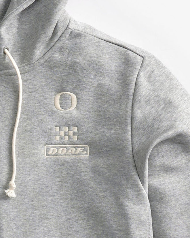 Logo detail of Gray Speedway zip up hoodie on a white background