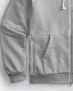 Side zipper detail of Gray Speedway zip-up hoodie on a white background