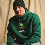 Teitum Tuioti wearing a green hoodie with a colorful logo and 'DOAF' text against a beige background