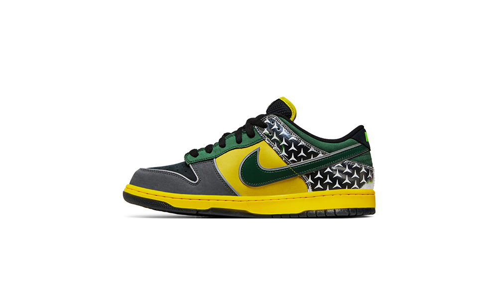 Lateral view of the DOAF What The Duck Nike Dunk Low “Home.” The colorful collage designs also pay homage to Oregon’s innovative use of textures, materials and stitching over the years. Incorporating reflective, metallic and neon elements that helped define Oregon’s distinct look on the field, the shoes both highlight the evolution of the Ducks' uniforms and celebrate the program’s continued impact on sports culture. 