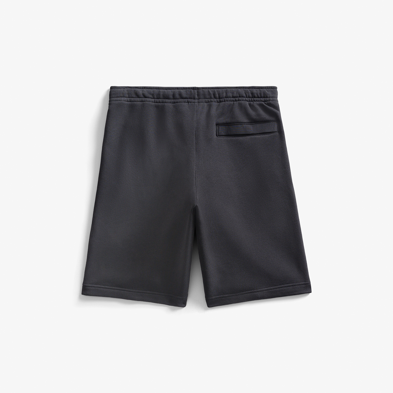 Back of the black shorts with a single pocket on the right leg on a light gray background